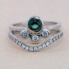 A delicate tourmaline engagement ring meets its match in this perfectly paired bridal set.