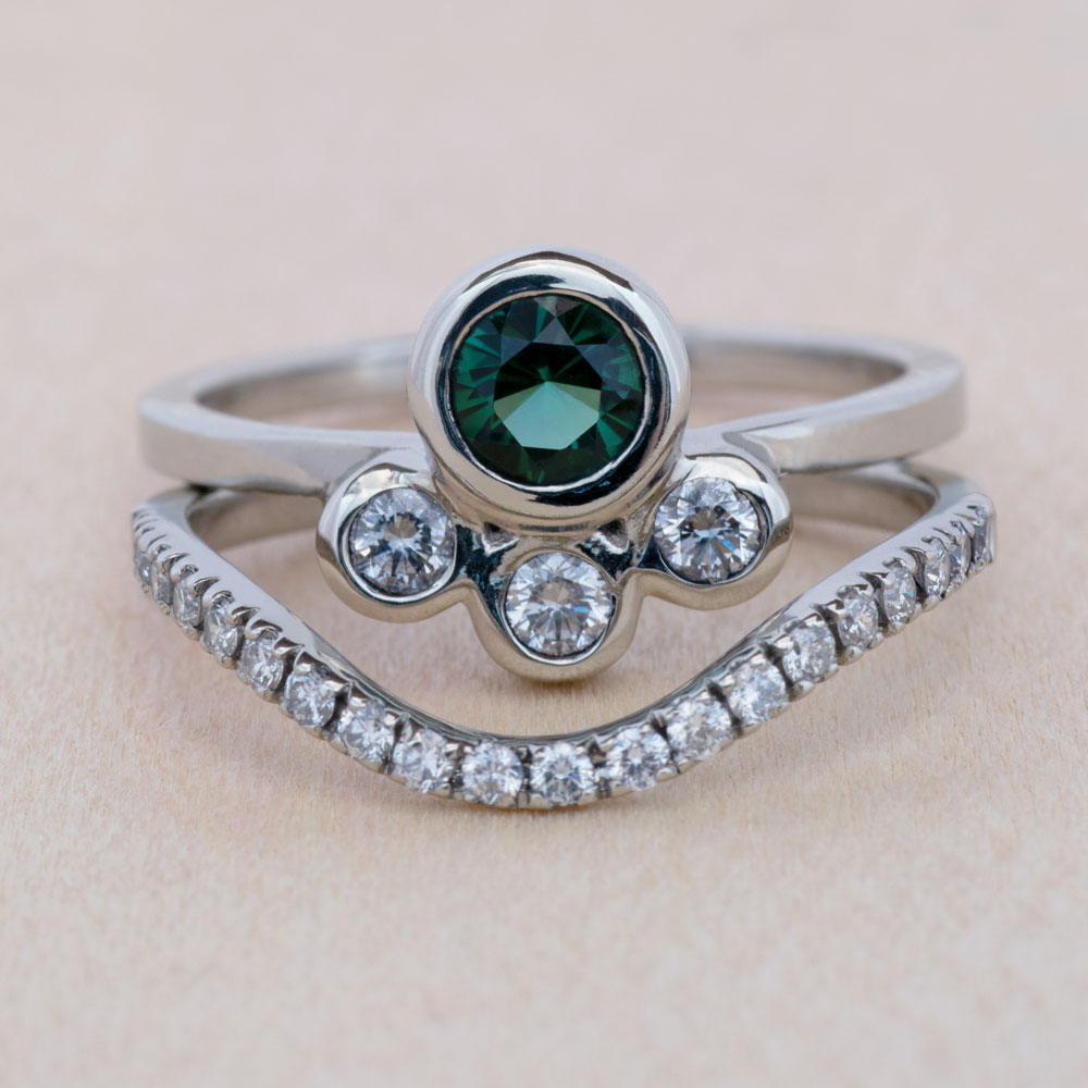 A delicate tourmaline engagement ring meets its match in this perfectly paired bridal set.