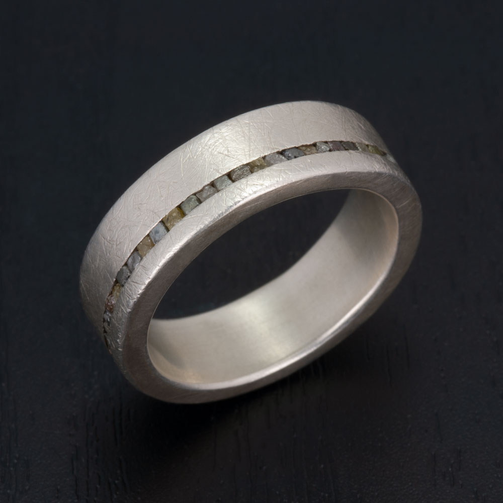 A focus on the detailed craftsmanship of our silver and rough diamond ring, where precision meets natural beauty.