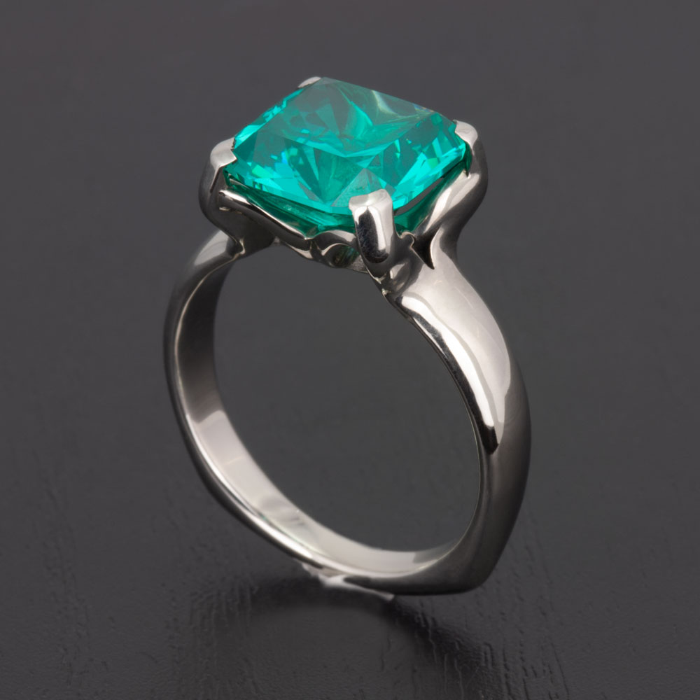 Indulge in luxury with this exquisite 14k white gold ring, featuring a lab-created garnet that sparkles with the promise of forever.