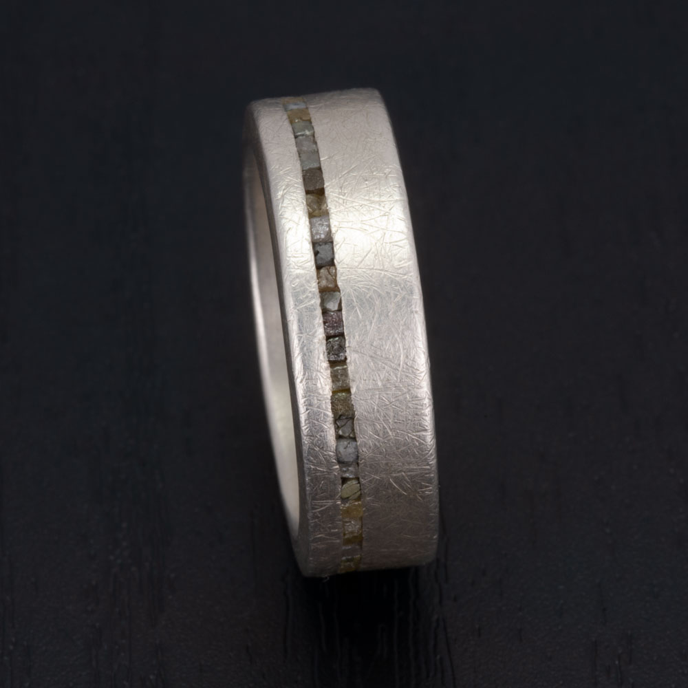 This silver and rough diamond ring as the epitome of urban chic, blending raw diamond beauty with sleek urban design.