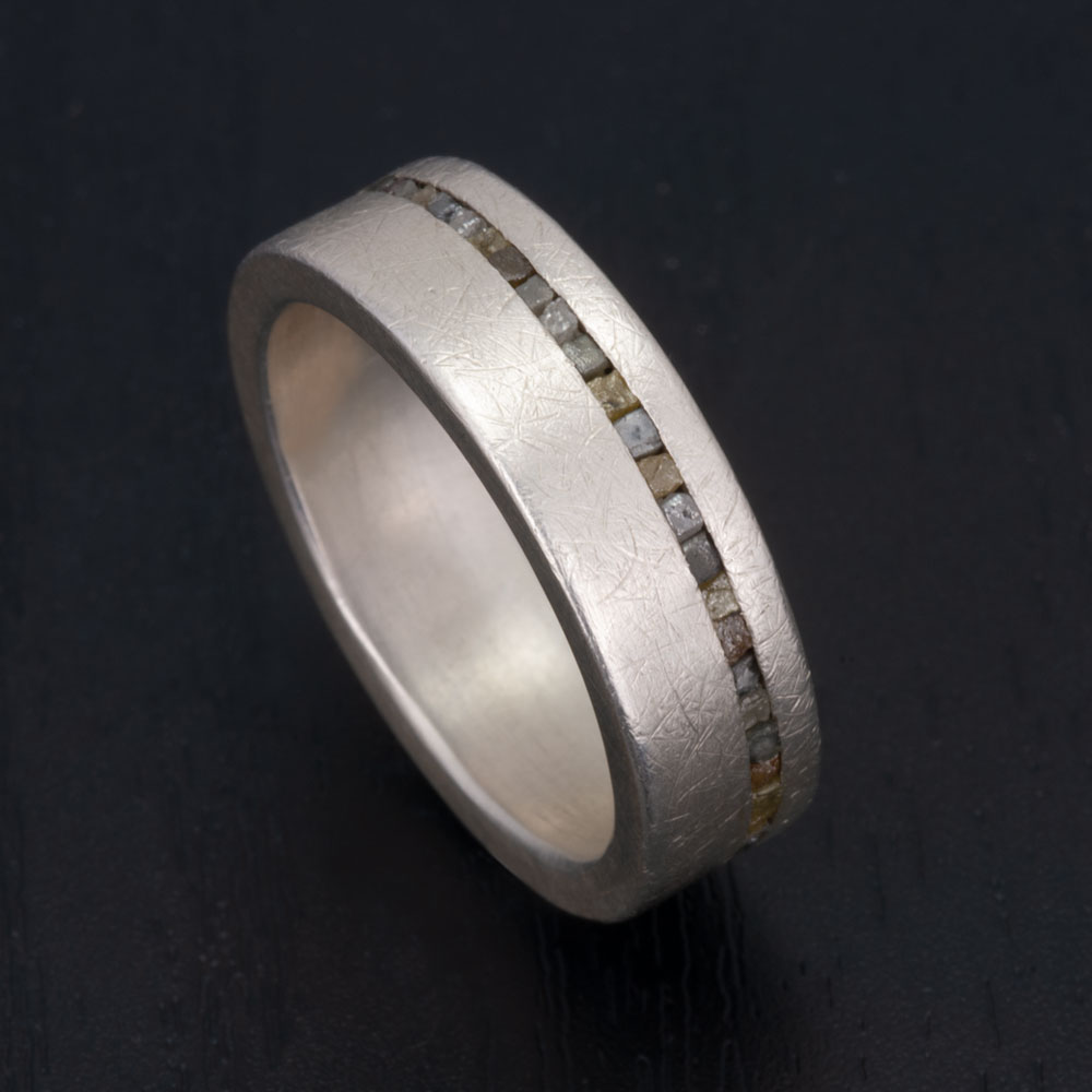 Close-up view of our silver and rough diamond ring, showcasing the intricate balance of rugged diamonds and rustic finish.