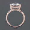 This ring is engagement ready, showcasing a stunning lab-created white sapphire set in 14k rose gold.