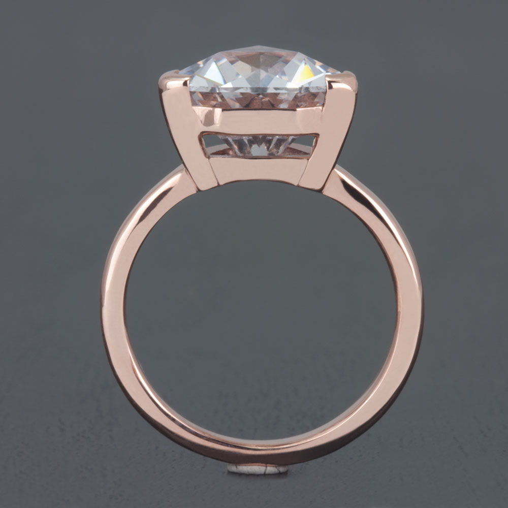 This ring is engagement ready, showcasing a stunning lab-created white sapphire set in 14k rose gold.