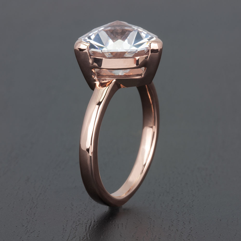 Choose ethical elegance with this 14k rose gold engagement ring, featuring a responsibly sourced lab-created white sapphire.
