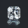 An image of a square cut, light blue aquamarine against a dark background.