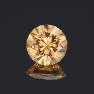 An image of a golden-peach garnet from Jeffrey Mine, Quebec, Canada