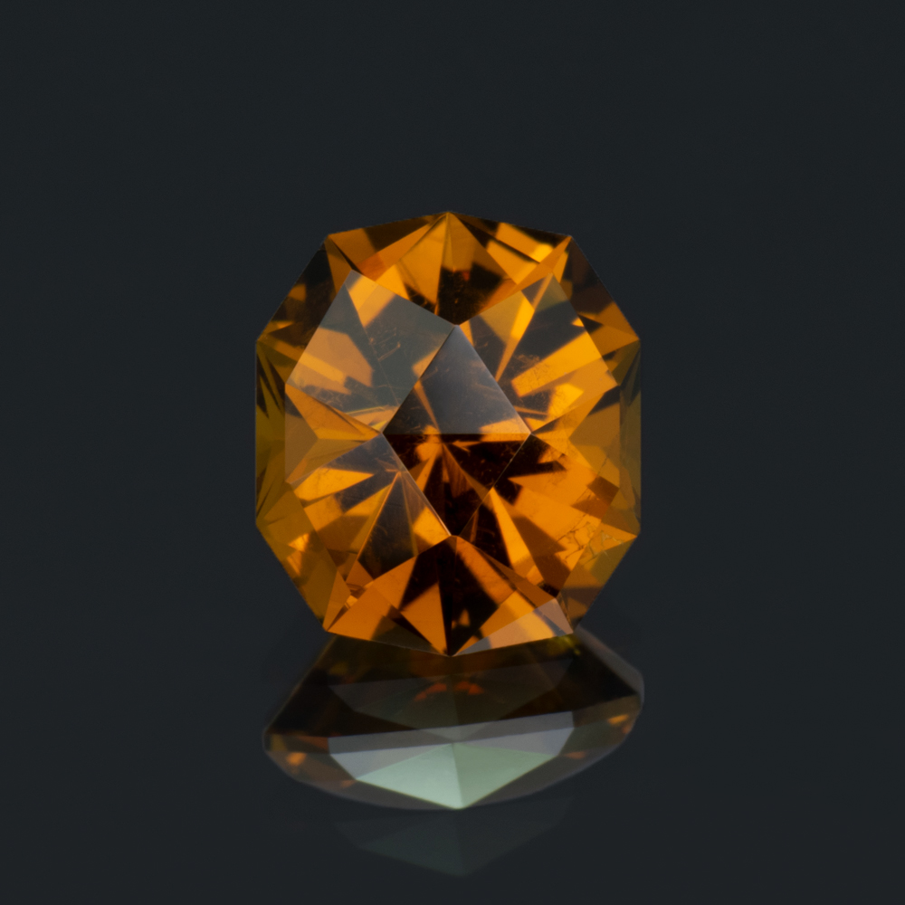 An image of an orange hessonite garnet that weighs 1.12 carats.
