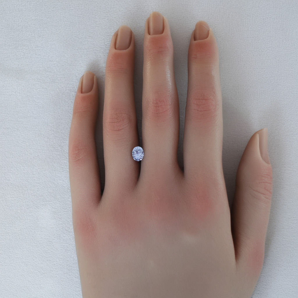 An image of a 1.06 carat pale purple oval sapphire on a hand.