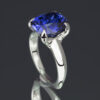 A stunning statement ring featuring a large, vibrant lab-grown blue sapphire elegantly mounted in gleaming 14k white gold.